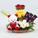 Flowers in a chocolate basket with a teddy bear