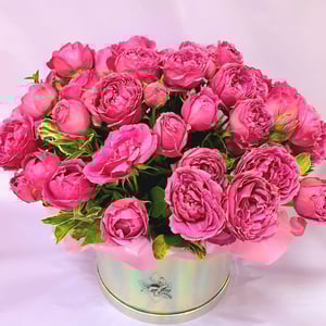 Bouquet of peony roses in a hat box