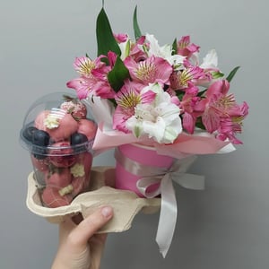 A bouquet and a glass of chocolate-dipped strawberries
