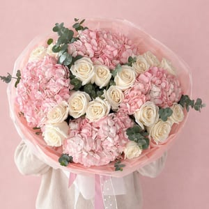 A graceful bouquet of white roses and pink hydrangeas.