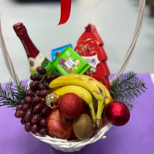 Fruit basket with champagne and sweets