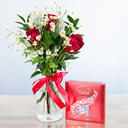A bouquet of roses and chocolate candies