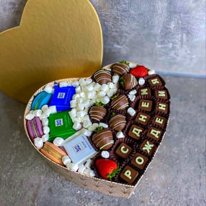 Little heart with candies and strawberries