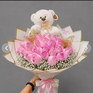 Bouquet of 42 pink roses with a small teddy bear.