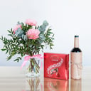 Pink gerberas with chocolates and wine