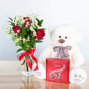 Roses and a teddy bear with chocolate candies