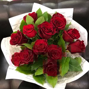 Bouquet of red roses with greenery