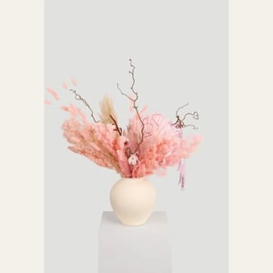 Soft pink and beige-toned dried floral arrangement