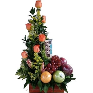 Arrangement of roses, fruits, and chocolate