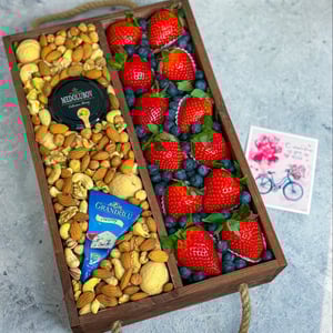 Box with nuts, honey, cheese, and berries